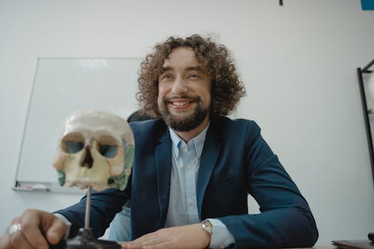 Engaging teacher with a model skull in a classroom, symbolizing knowledge and science education.