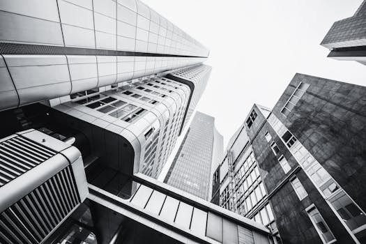 Dramatic low angle shot of modern skyscrapers in monochrome.