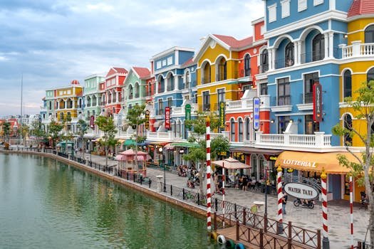 Vibrant, colorful buildings line a serene canal, evoking a Venetian feel in this urban scene.