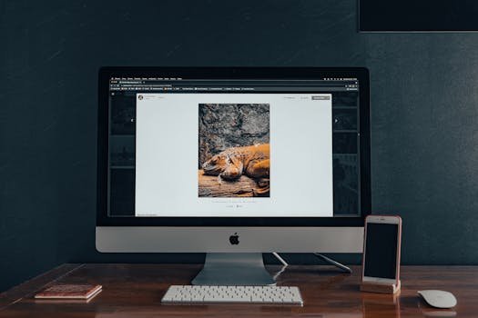 Stylish indoor workspace with a computer and smartphone on a wooden desk.